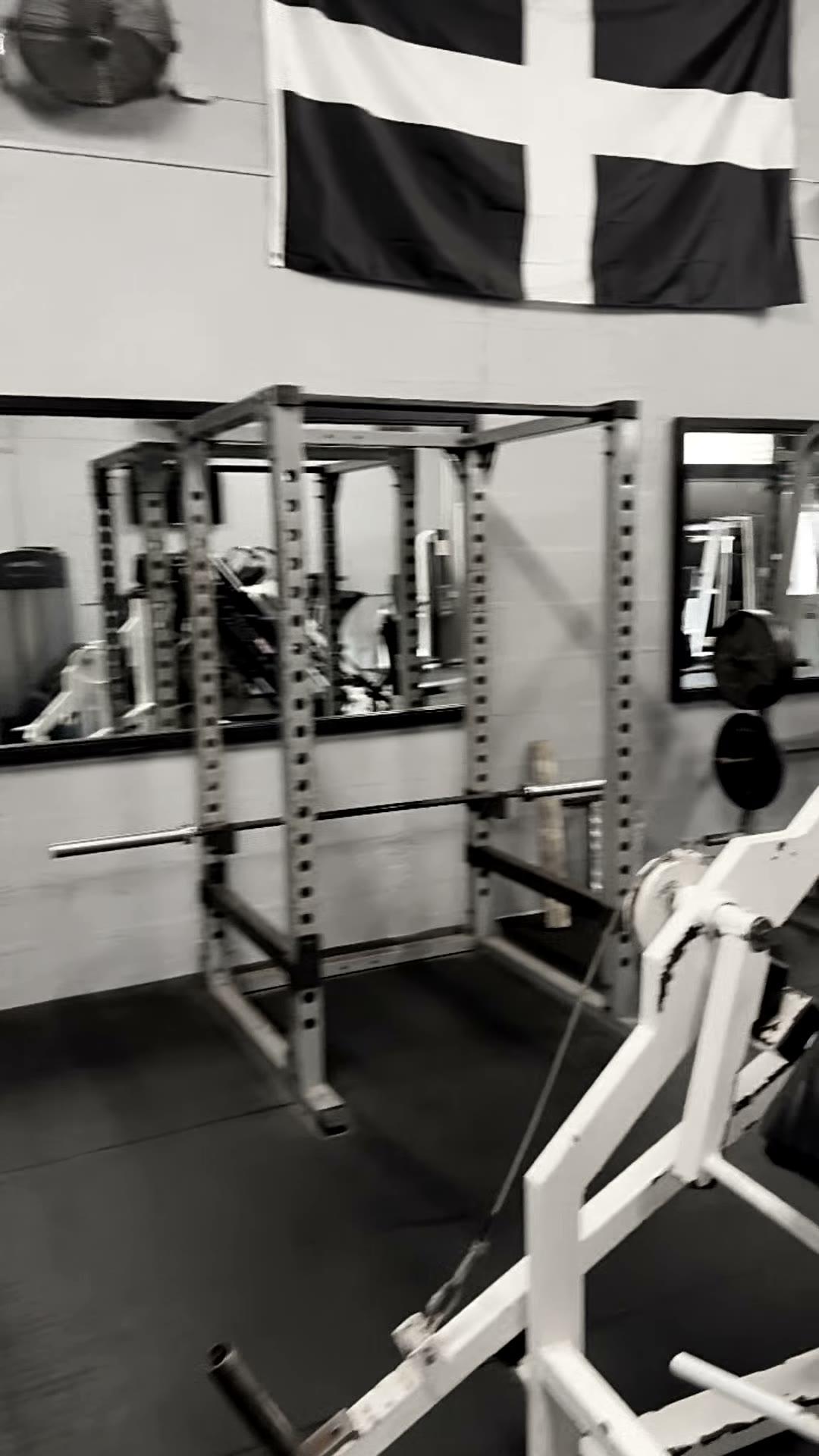 Inside Bude Gym: the St Piran flag above a row of power racks