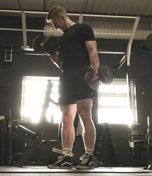 Dumbbell curls against the bright window