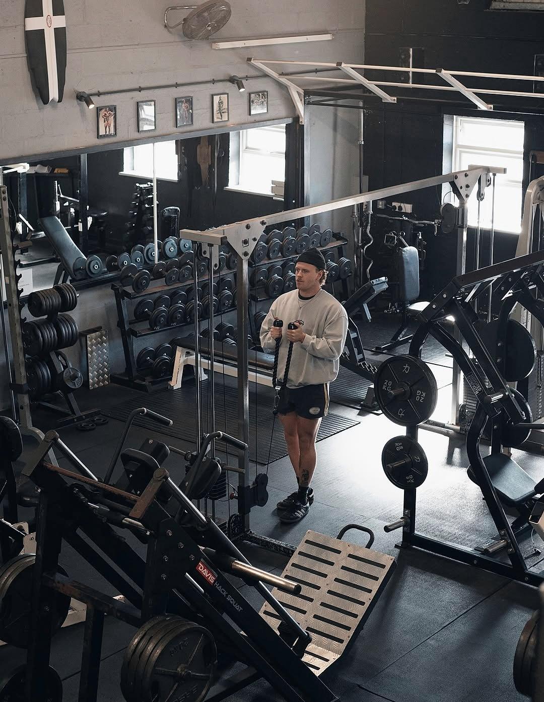 The gym floor with racks, benches and plate-loaded machines