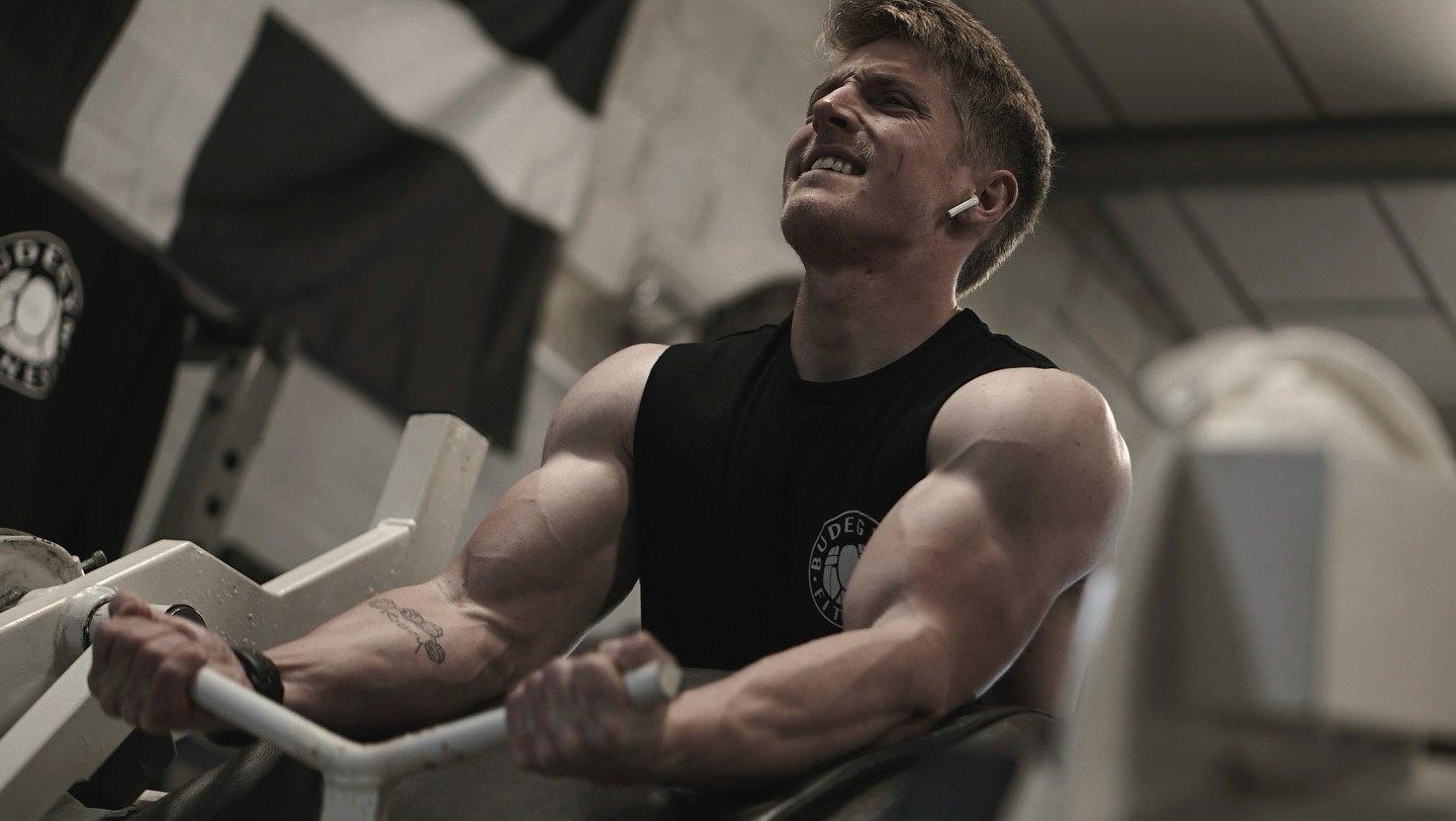 A member doing preacher curls
